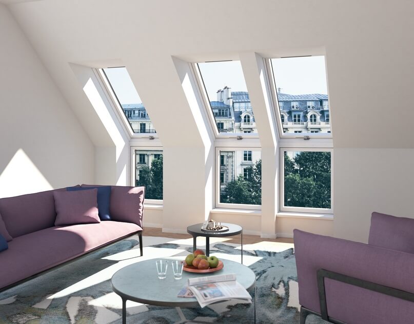 A living room with three tall roof windows showing a view of the city