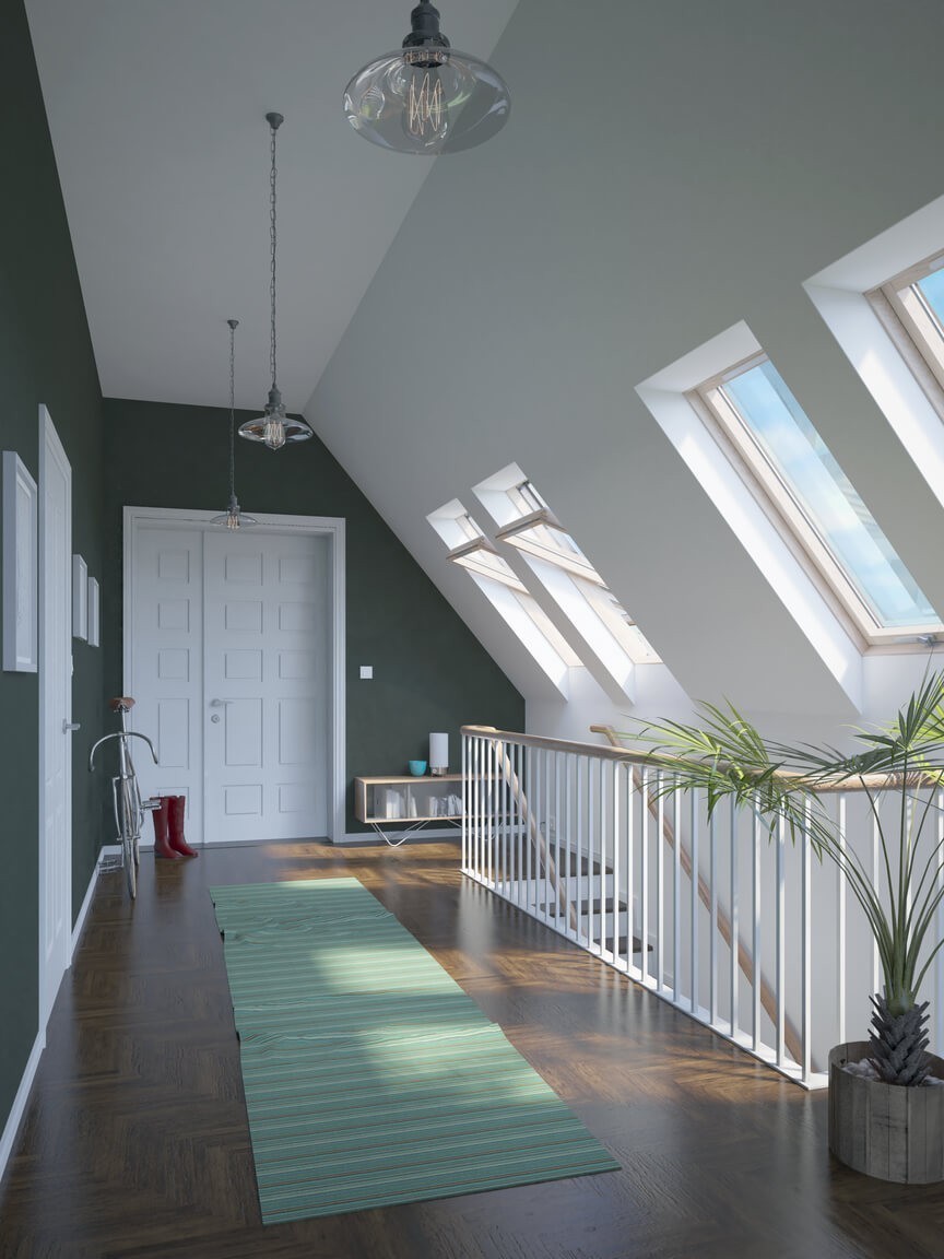 A bright hallway with a row of roof windows along one wall