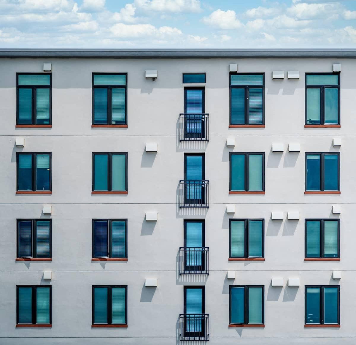 a flat roof building, with blue tinted windows, with black frames.