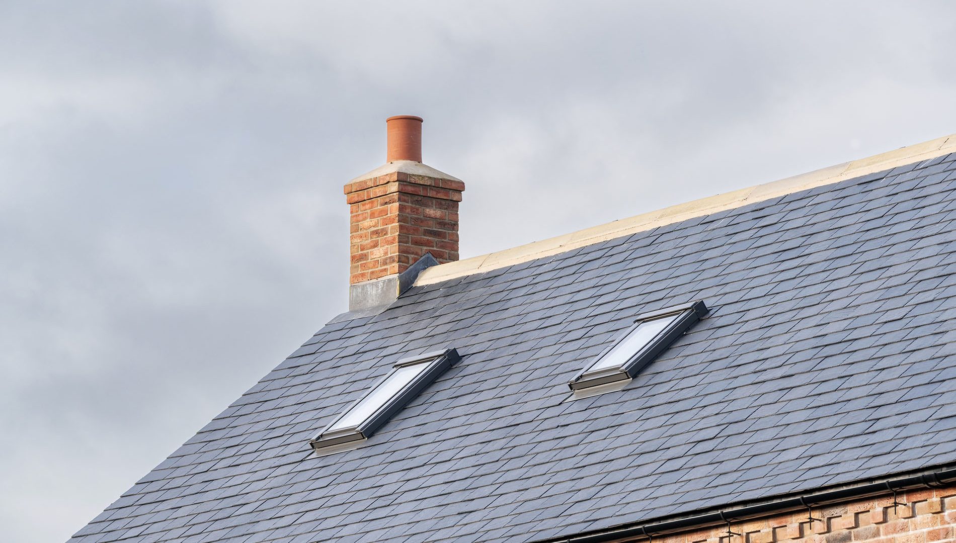 Roof windows installed for loft conversion, viewed from external.