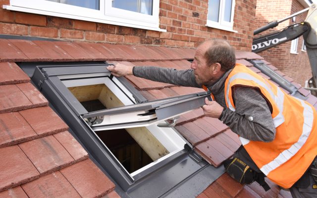 Installer fixing a Dakea roof window.