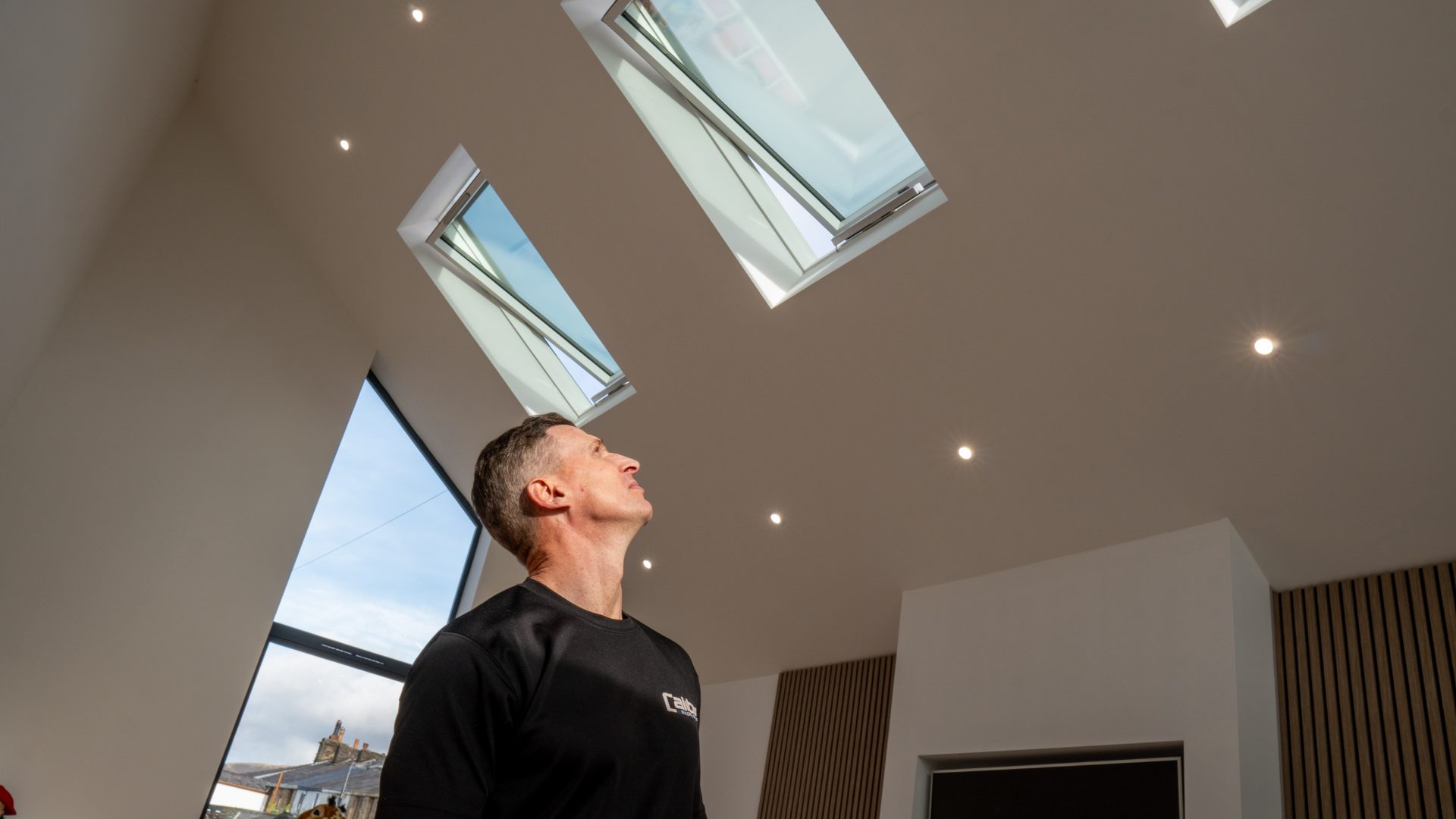 Pitched Dakea roof window opened within a new build estate.