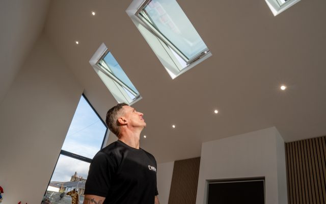 Pitched Dakea roof window opened within a new build estate.
