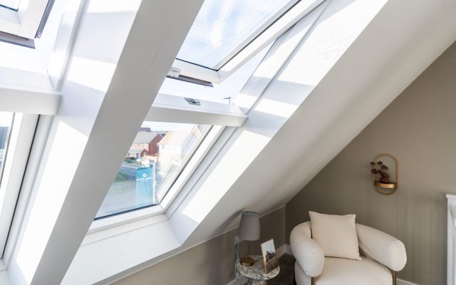 A Dakea pitched roof window open in a lounge area.